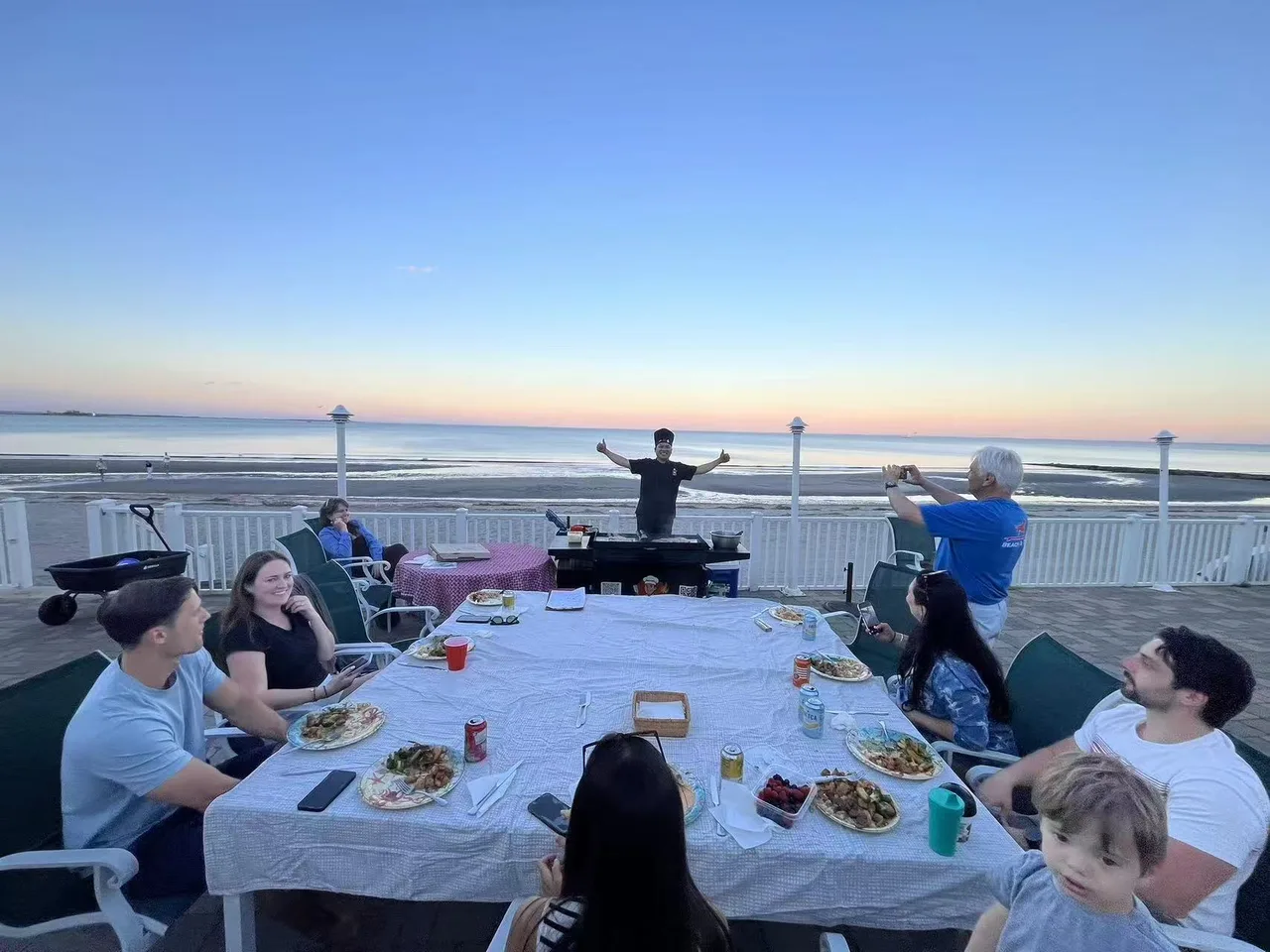 Hibachi chef performing at a sunset backyard party