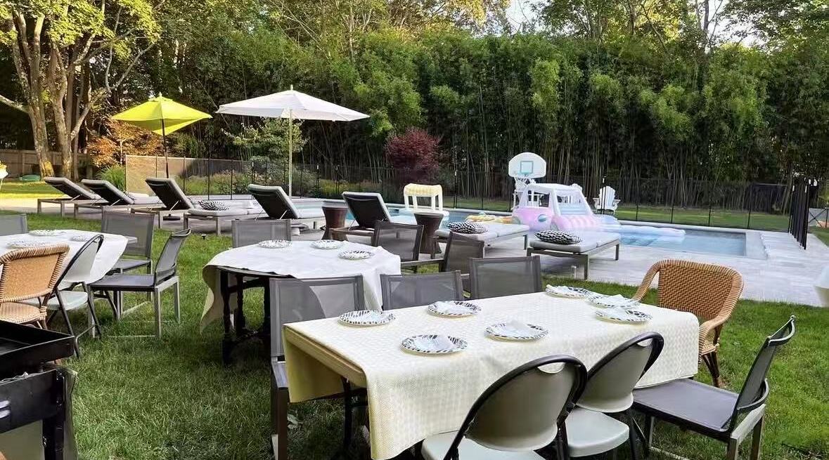 Table set up for a hibachi dinner beside a pool